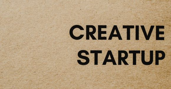 Creative Entrepreneurship - Close-Up Shot of a Creative Startup Text on a Brown Paper